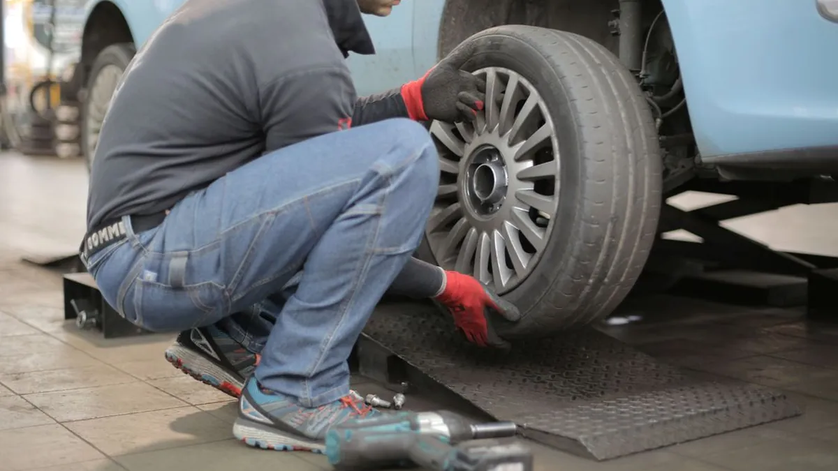 Mechanic inspecting a car engine in a clean independent garage workshop