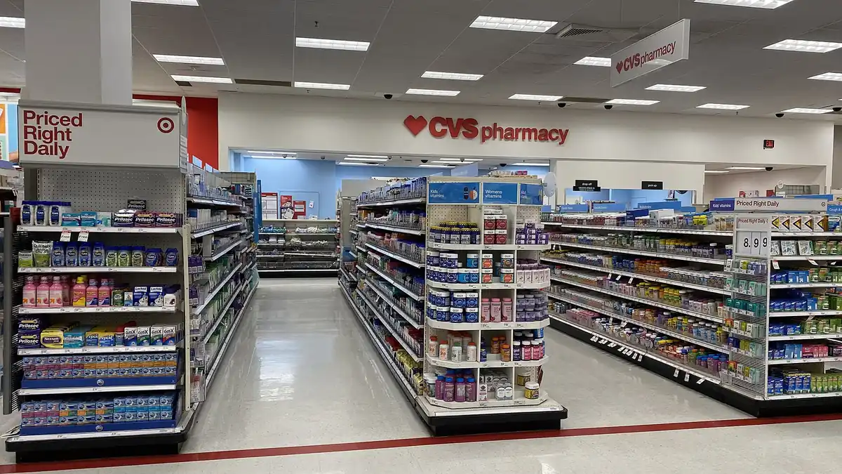 Pharmacy shelves stocked with vitamins and health products where travellers buy travel health supplies and read product labels